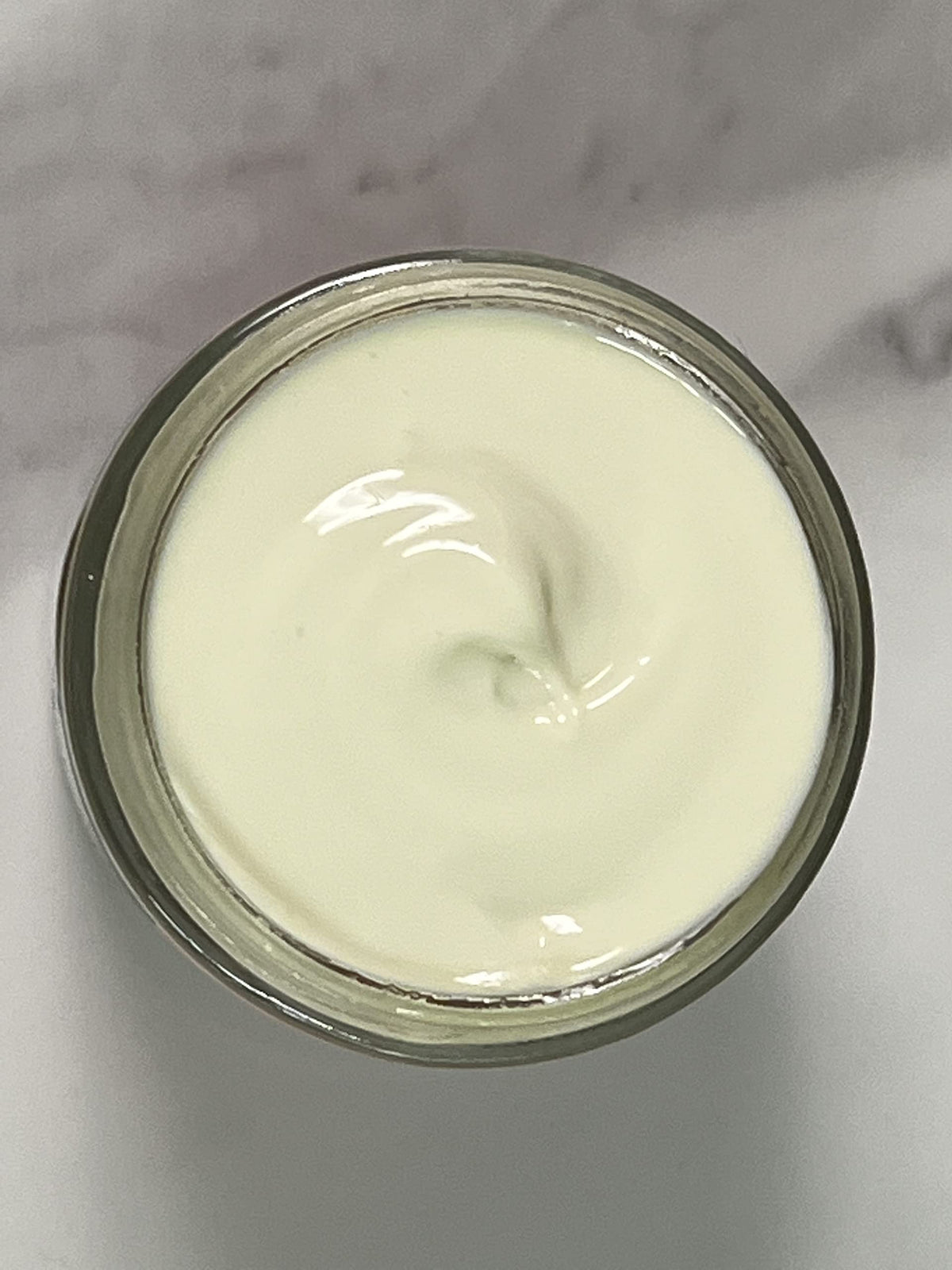 Indian Meadow Herbals cream swiped on hand demonstrating quick absorption and hydration