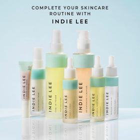 Indie Lee cleanser beside travel items showing compact 4.2 oz size
