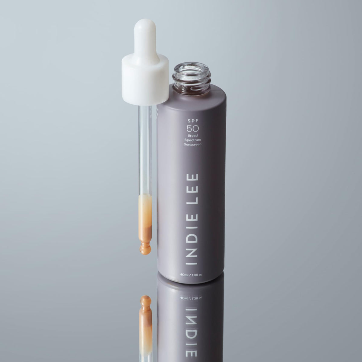 Indie Lee primer dispensed on hand, showing blendable texture and hydration