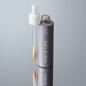 Indie Lee primer dispensed on hand, showing blendable texture and hydration