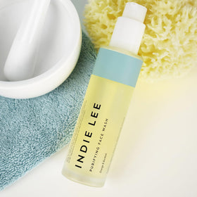 Indie Lee botanical ingredients flatlay highlighting natural extracts