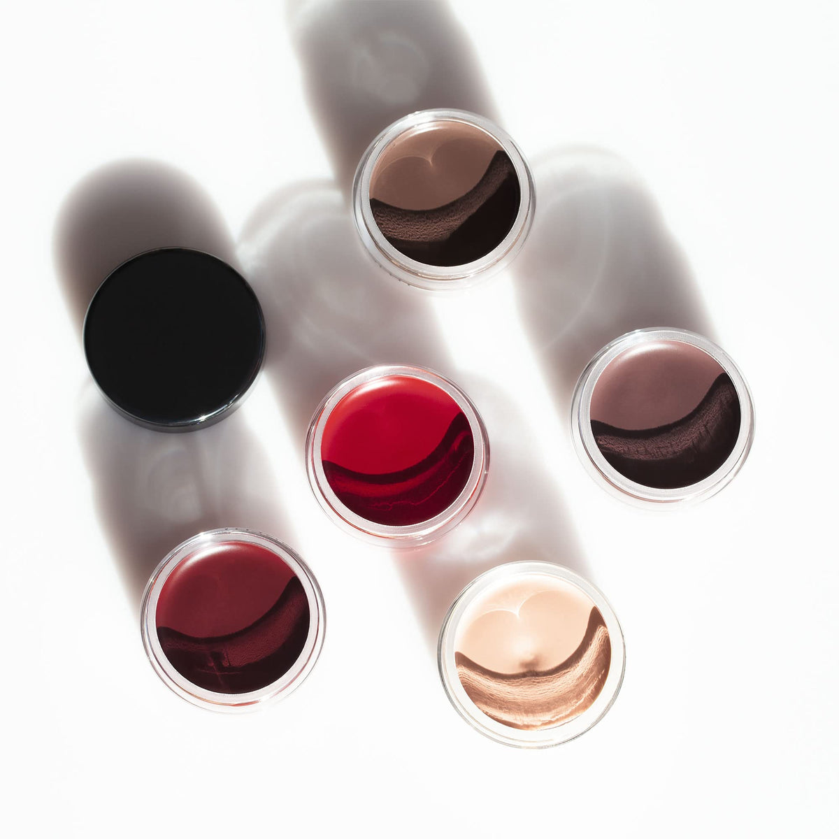 Inglot AMC gel next to coin for size comparison highlighting travel-friendly compactness