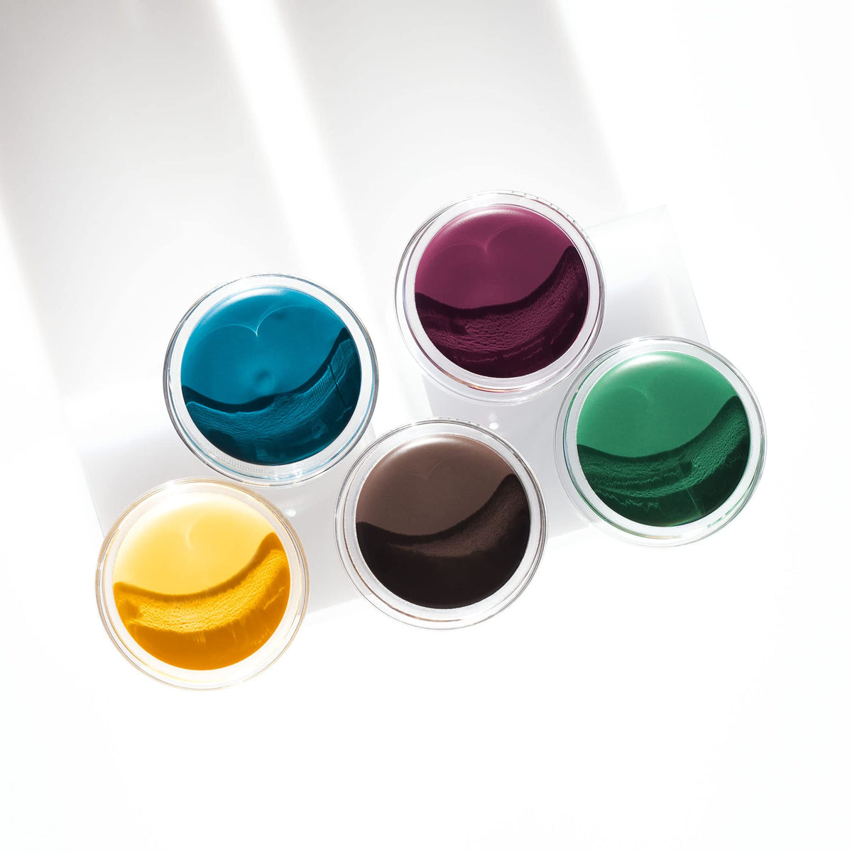 Inglot AMC gel next to coin for scale showing compact size and travel-friendly convenience