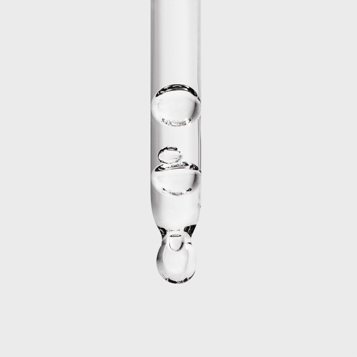 Inglot Duraline pipette detail dispensing a drop for controlled, hygienic application benefit