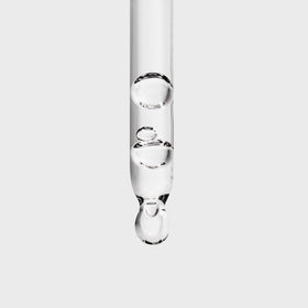 Inglot Duraline pipette detail dispensing a drop for controlled, hygienic application benefit