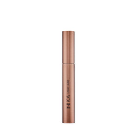 INIKA long lash scale comparison with coin indicating compact size and travel-friendly benefit