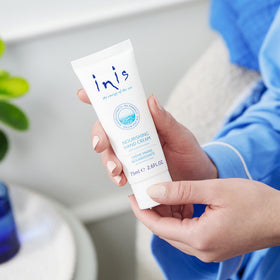 Inis cream texture on fingertip showing quick-absorbing benefit
