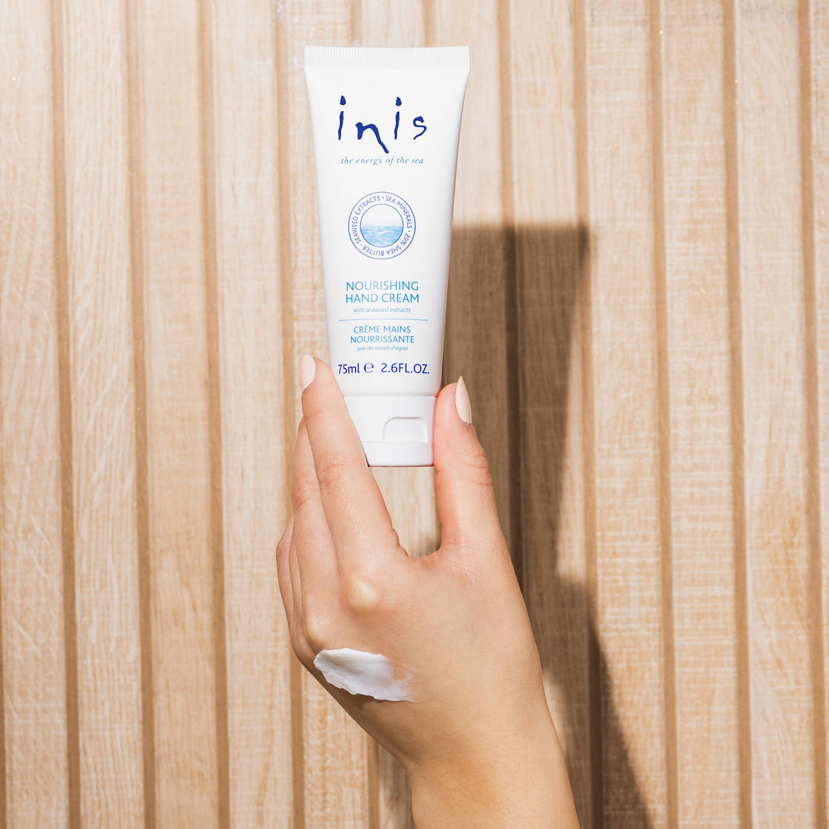 Inis being applied to hands demonstrating fast hydration benefit