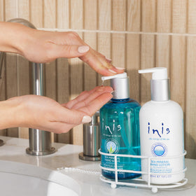 Inis brand hand lotion label detail highlighting moisturizing shea butter and nourishment