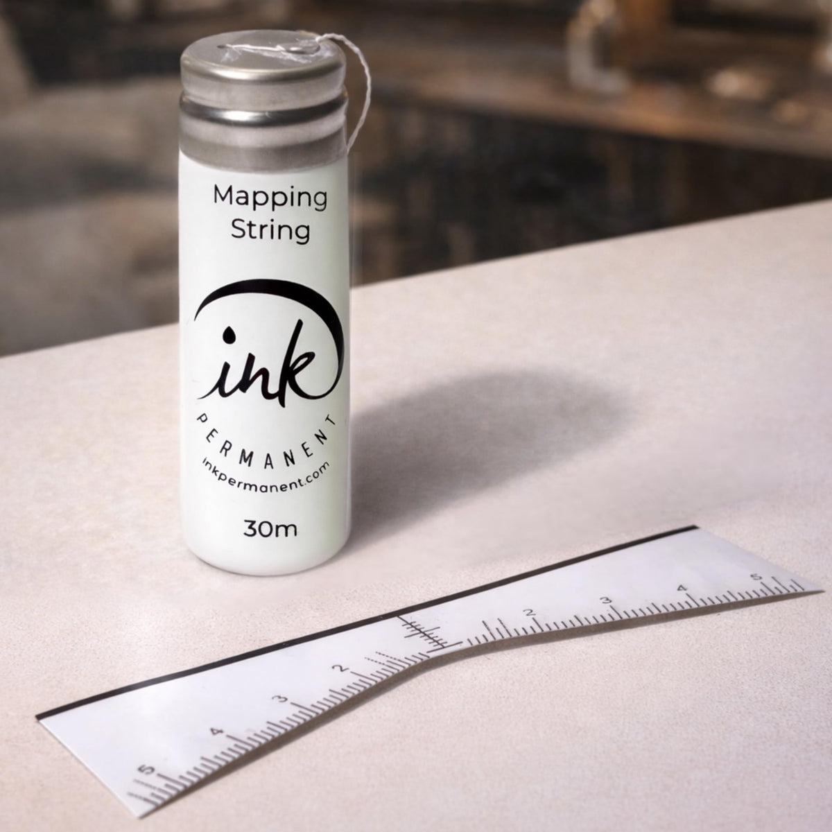 Ink Permanent close-up of pre-inked mapping string delivering crisp guide lines