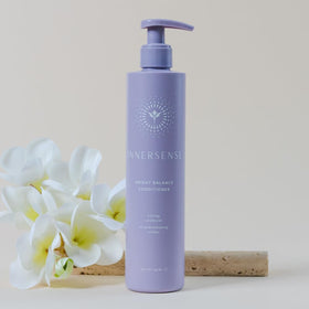 INNERSENSE bottle on bathroom shelf styled with plants conveying clean-beauty benefit