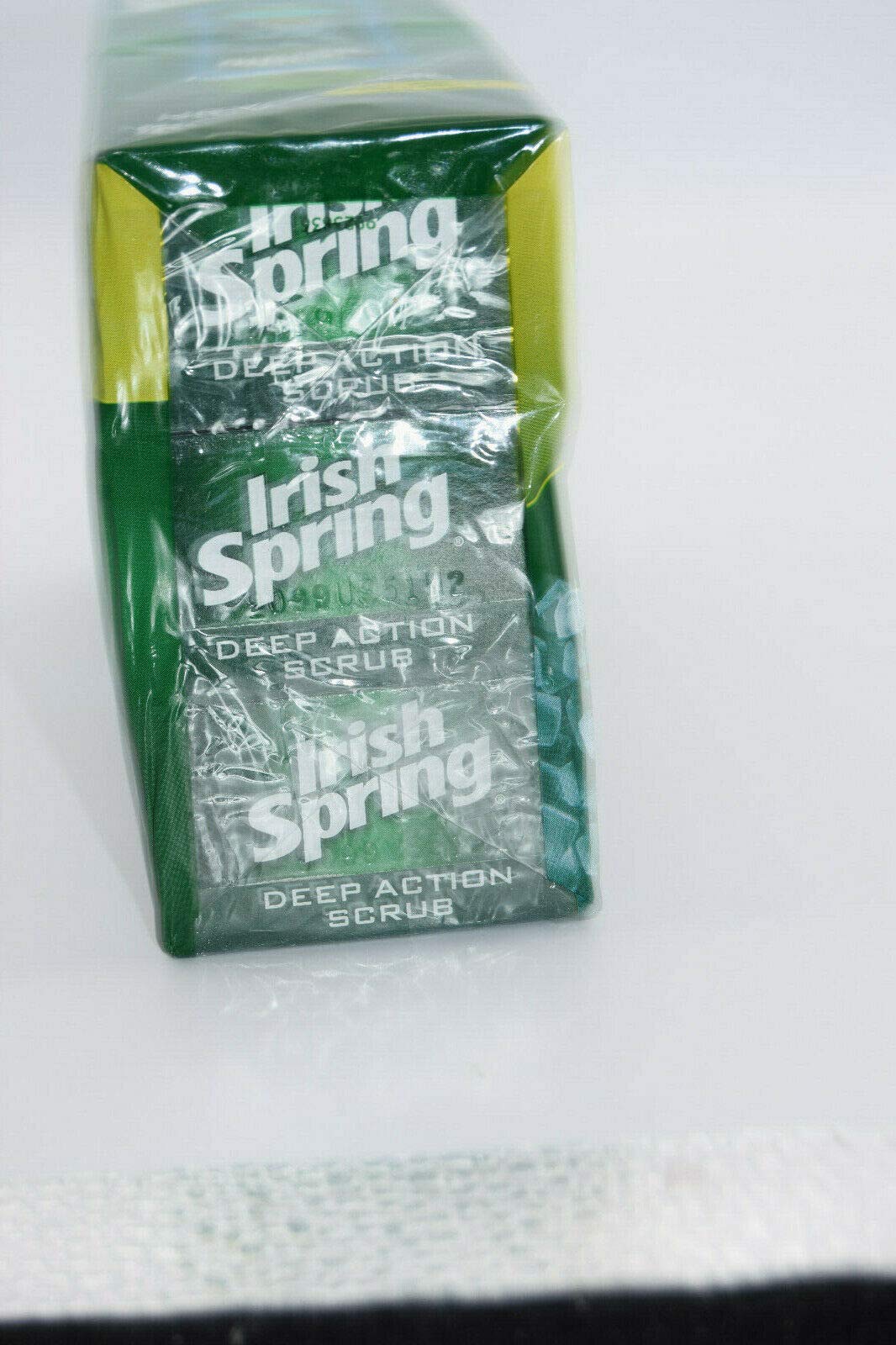 Irish Spring bar in hand under running water showing lather and refreshing benefit