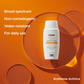 ISDIN Eryfotona beside a ruler for scale showing the 3.4 fl oz travel friendly size
