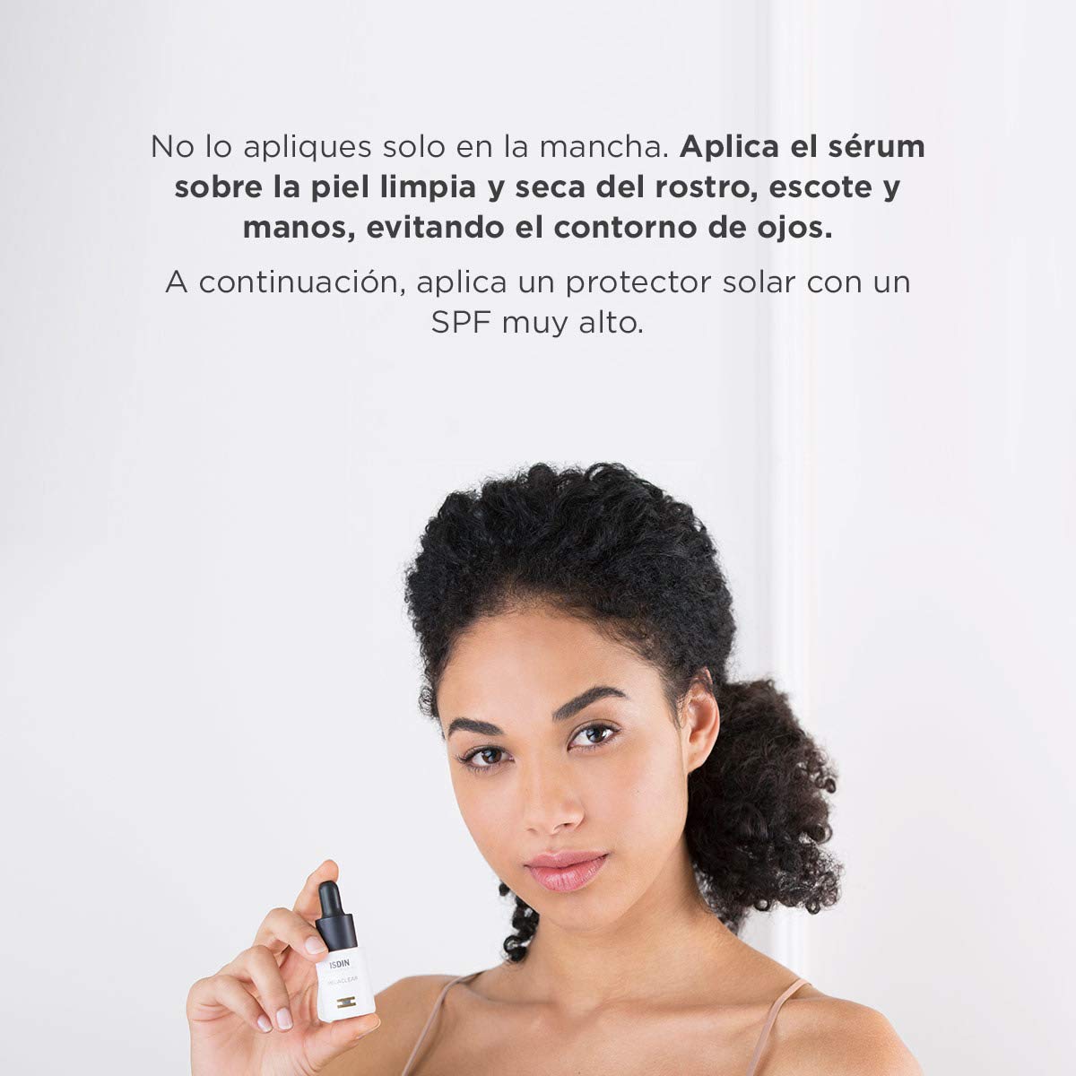 ISDIN bottle beside night cream and towel, suggests nighttime skincare routine use