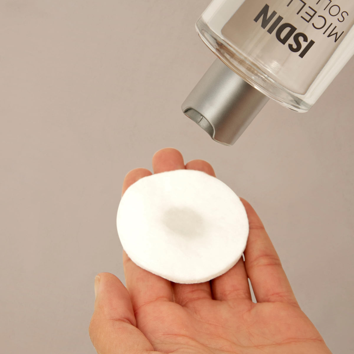 ISDIN close-up of clear micellar solution droplets to show gentle, non-oily texture