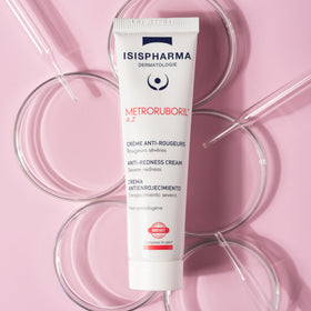 IsisPharma cream texture on fingertip demonstrating lightweight absorbency