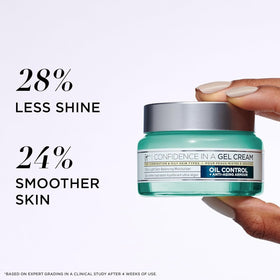 IT Cosmetics jar next to hand for scale showing 2.0 oz travel-friendly size