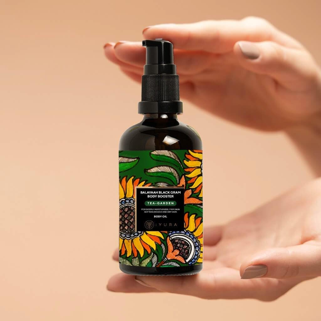 The Ayurveda Experience Balaayah bottle next to a hand for size and easy-use reference