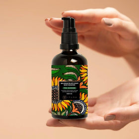 The Ayurveda Experience Balaayah bottle next to a hand for size and easy-use reference