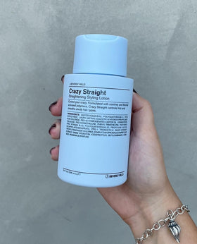 Stylist using J Beverly Hills lotion while blow-drying hair, improved frizz control