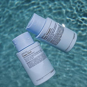 J Beverly Hills lotion pouring from bottle, showing smooth consistency for easy application