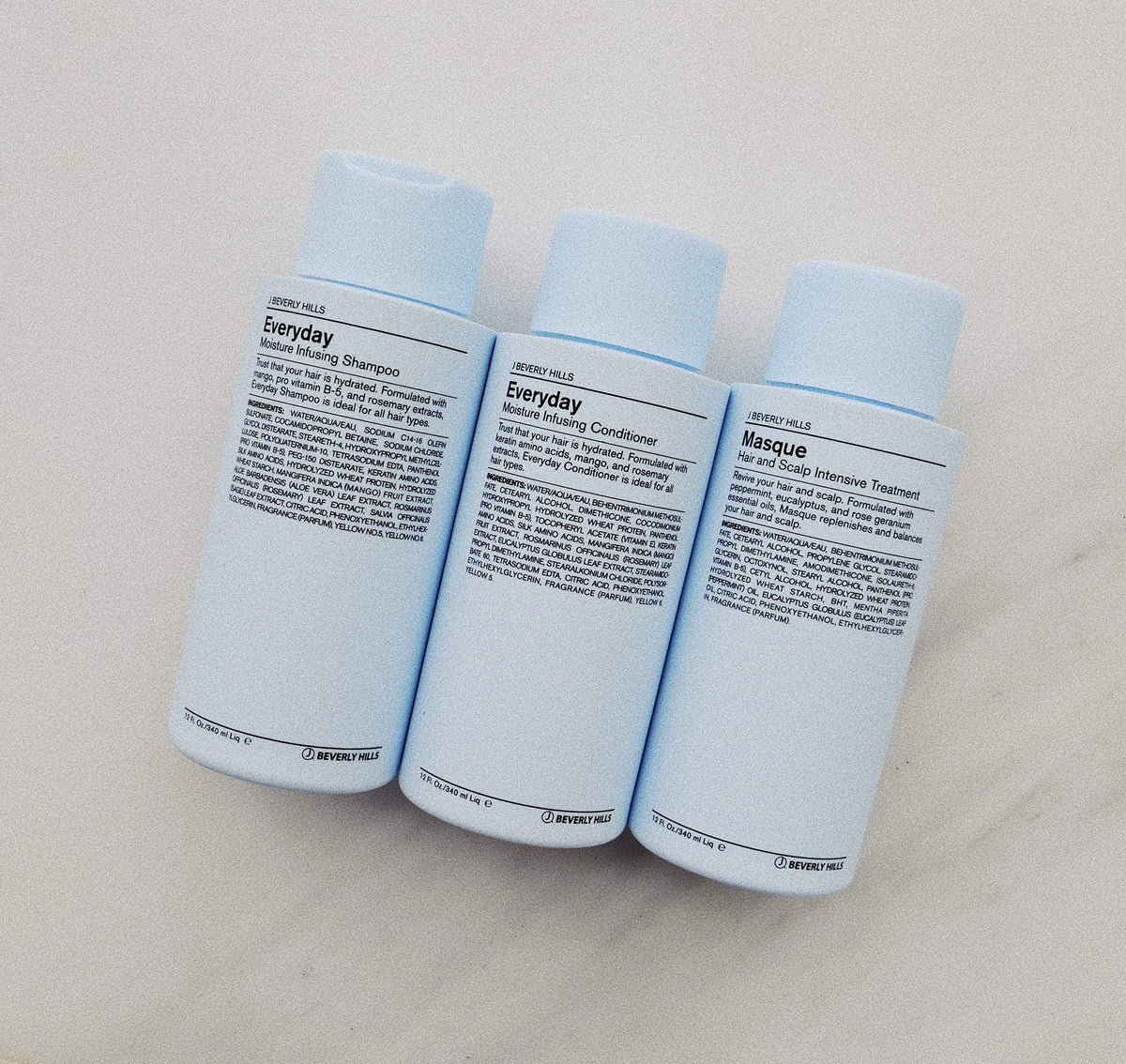 J Beverly Hills 12 oz bottle held in hand to show true size and everyday convenience
