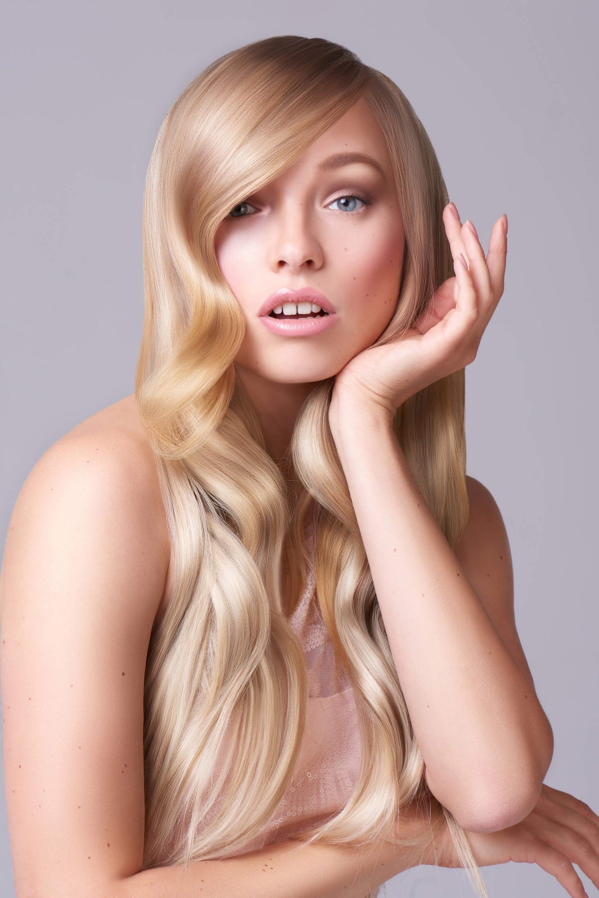 Argan and coconut ingredients staged with bottle, J Beverly Hills nourishing oil benefits