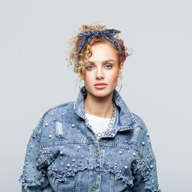 Jaciya headband on hand to show scale and easy portability benefit