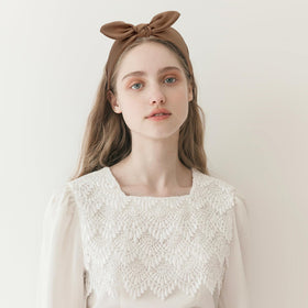 Jaciya hand holding headband showing true width and size-fit benefit