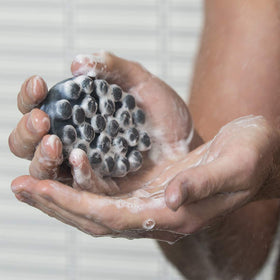 Jack Black close-up of raised nubs and jojoba beads, highlights gentle massage benefit