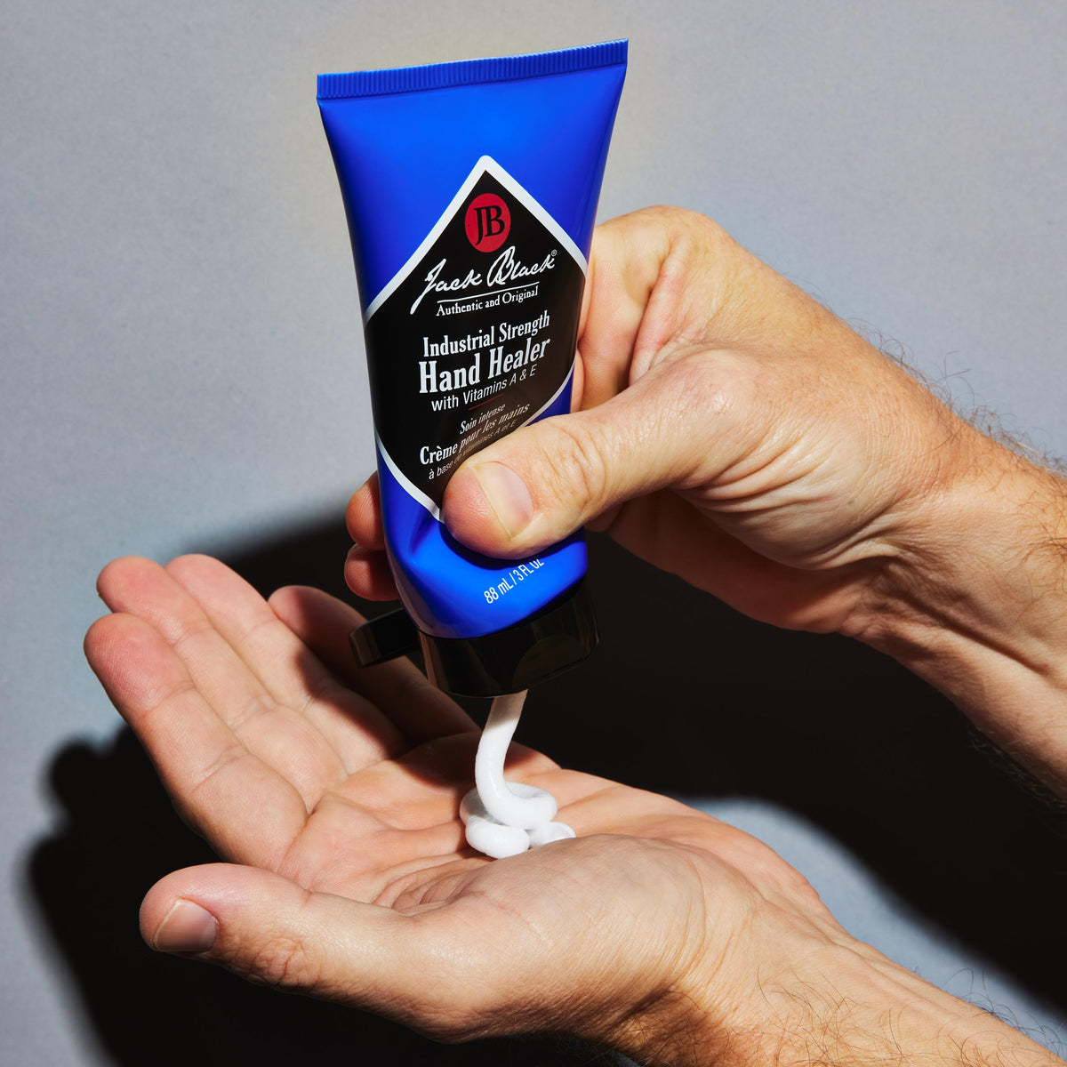 Jack Black hand healer being applied to hands to soothe dry skin and cuticles