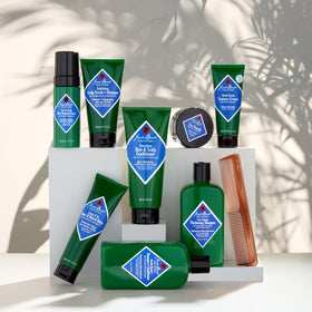 Hand applying Jack Black cream into hair for hydration and anti-frizz manageability