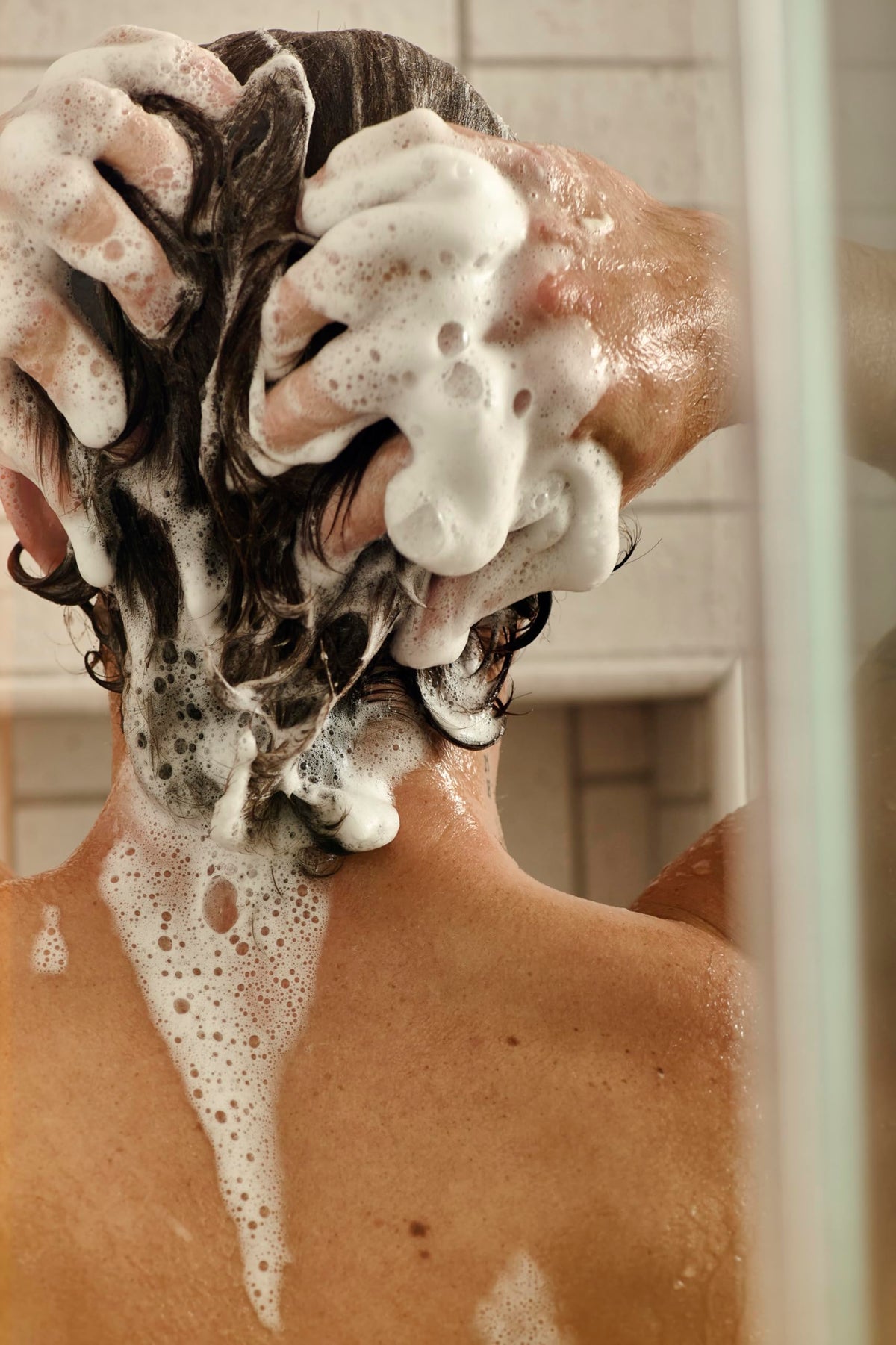 Jack Henry shampoo creating gentle lather in hand for effective cleansing