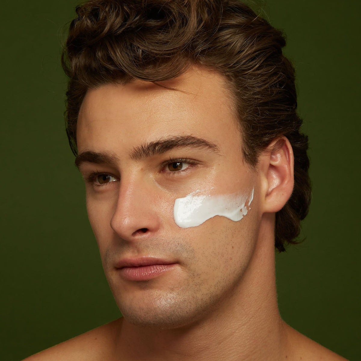 Jackfir applying moisturizer to face demonstrating smooth non-greasy finish