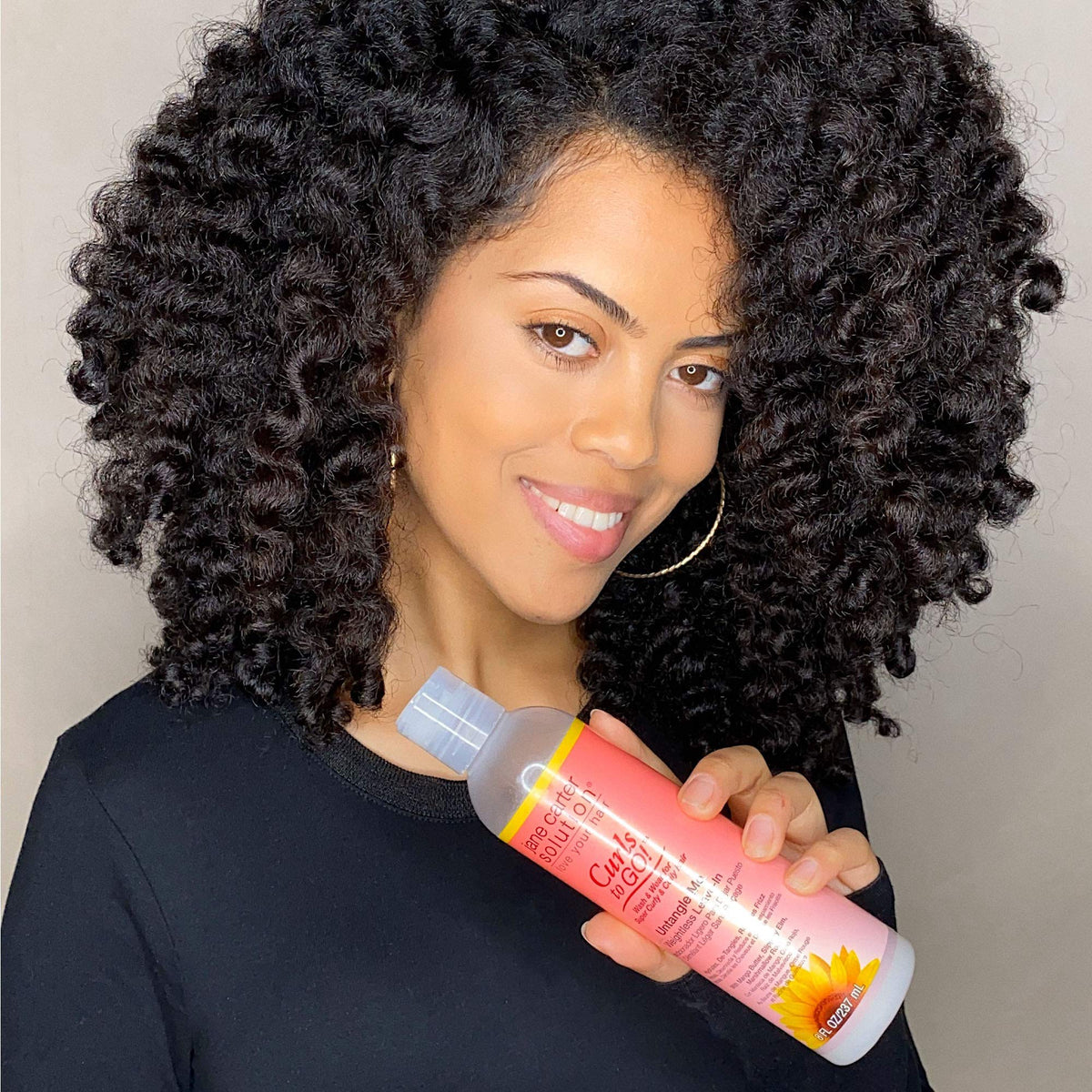 Jane Carter Solution creamy texture on hand showing smooth slip for detangling