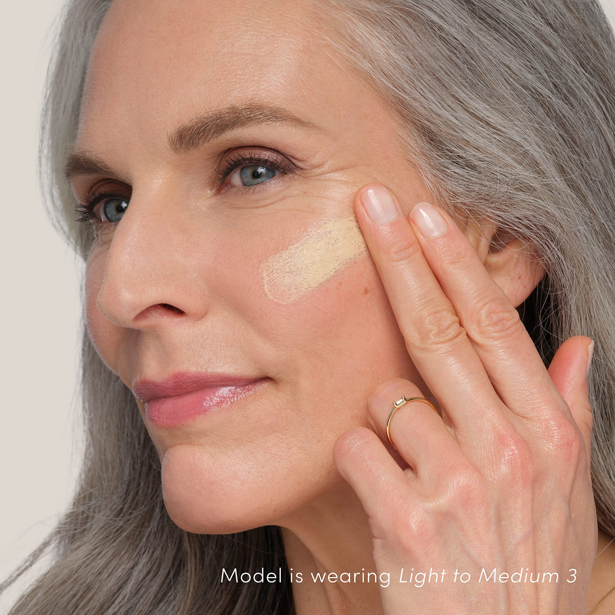 jane iredale applying serum with fingertips for natural finish