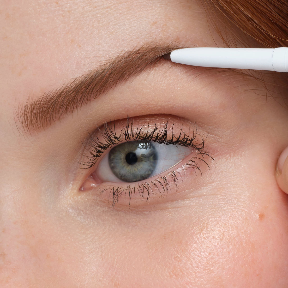 jane iredale pencil held in hand to show compact size and travel-friendly convenience