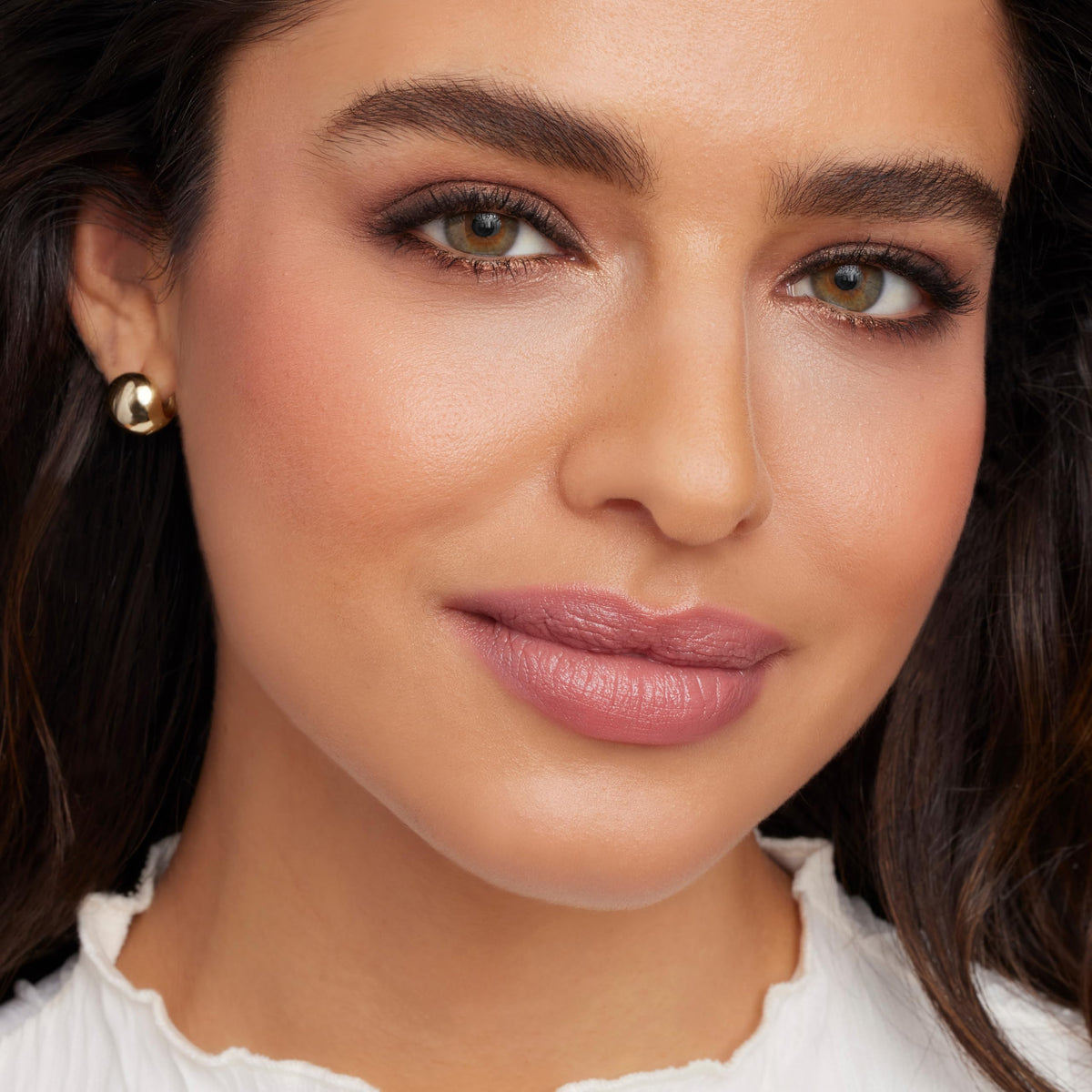 jane iredale lipstick in hand demonstrates size and portable convenience