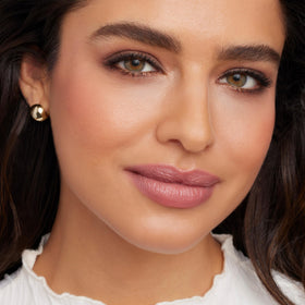 jane iredale lipstick in hand demonstrates size and portable convenience