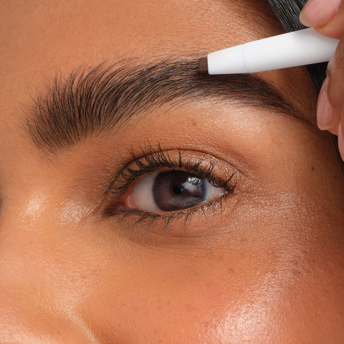 jane iredale lifestyle bag shot illustrating portable brow tool for touch-ups