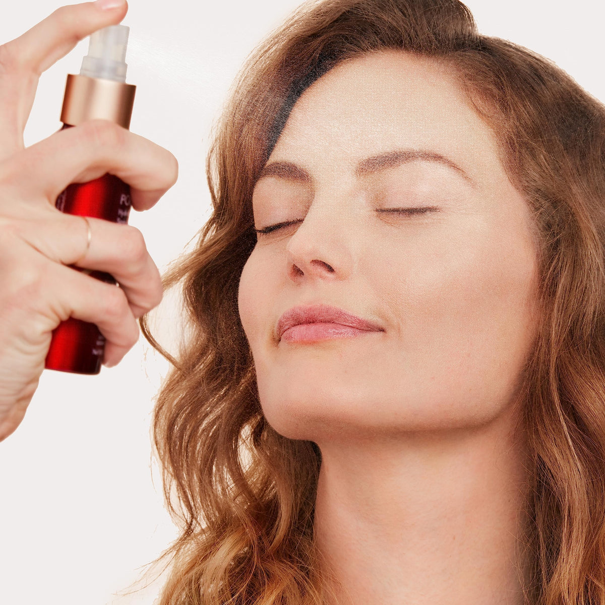 jane iredale spray held in hand demonstrating 3.04 fl oz travel-friendly size