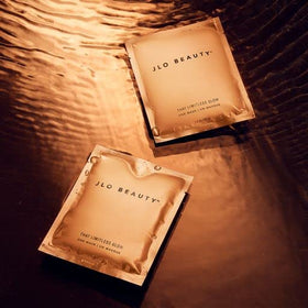 JLO BEAUTY mask held in hand for scale emphasizing travel-friendly convenience