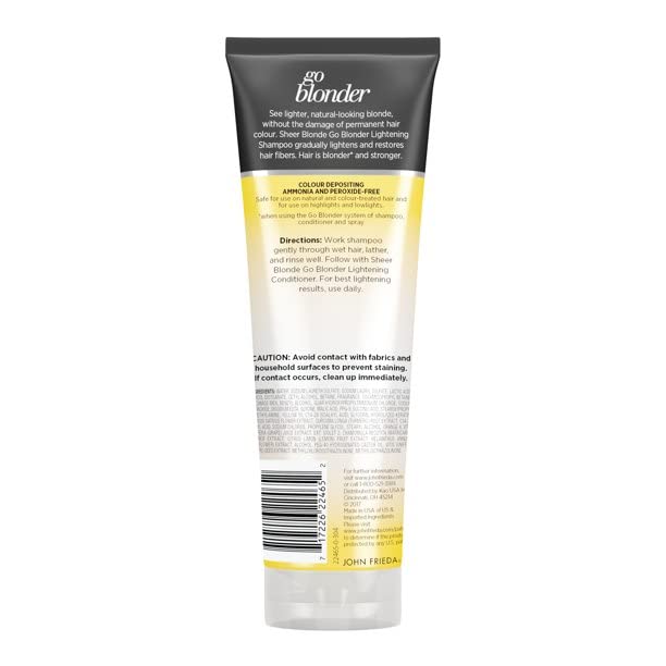 John Frieda bottle held in hand to show accurate size and scale