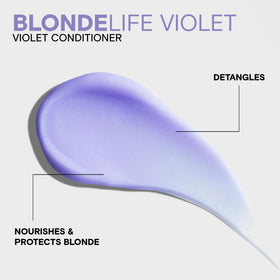 Creamy violet-tinted conditioner texture close-up demonstrating pigment and moisturizing consistency
