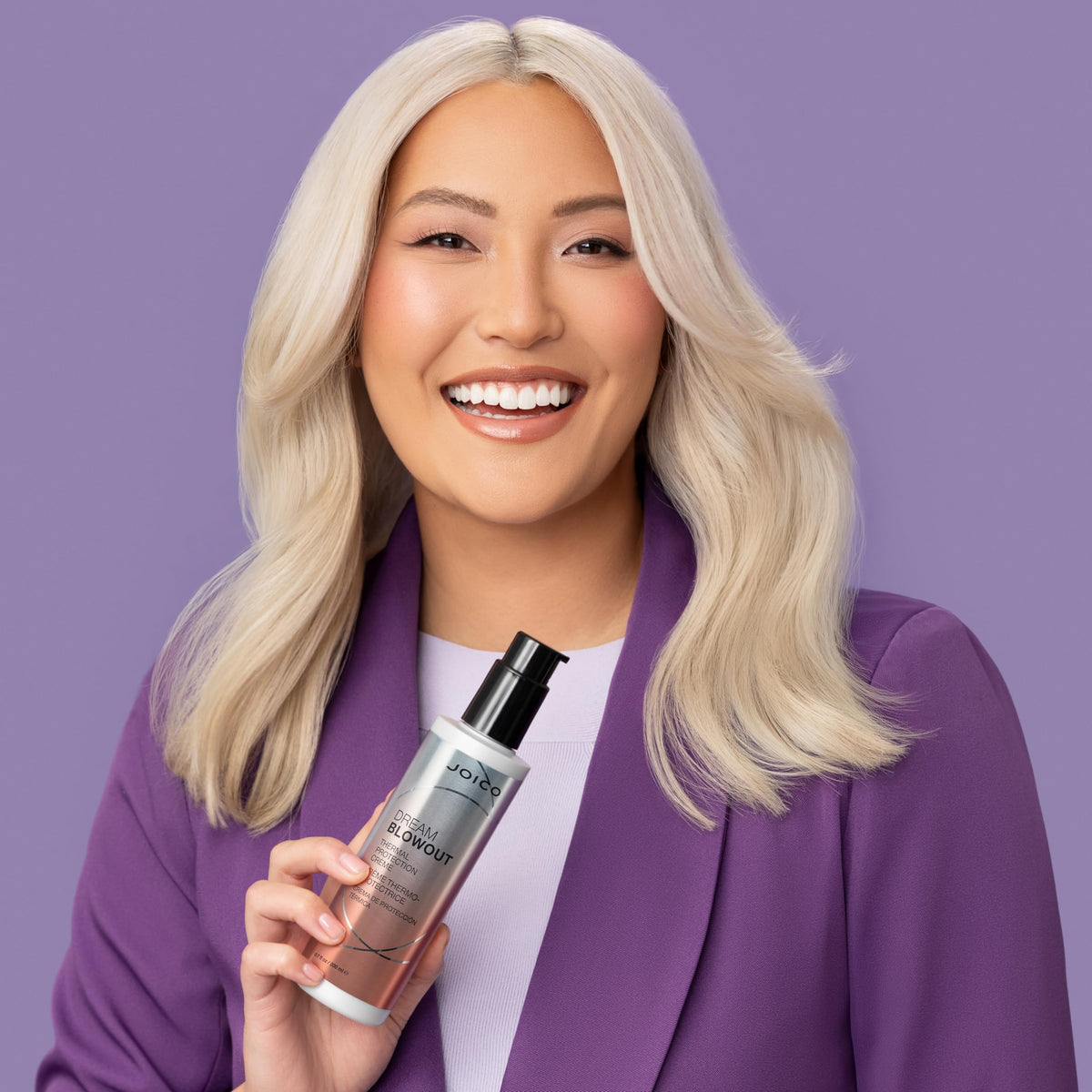 Joico 6.7 fl oz bottle next to hand to show true size