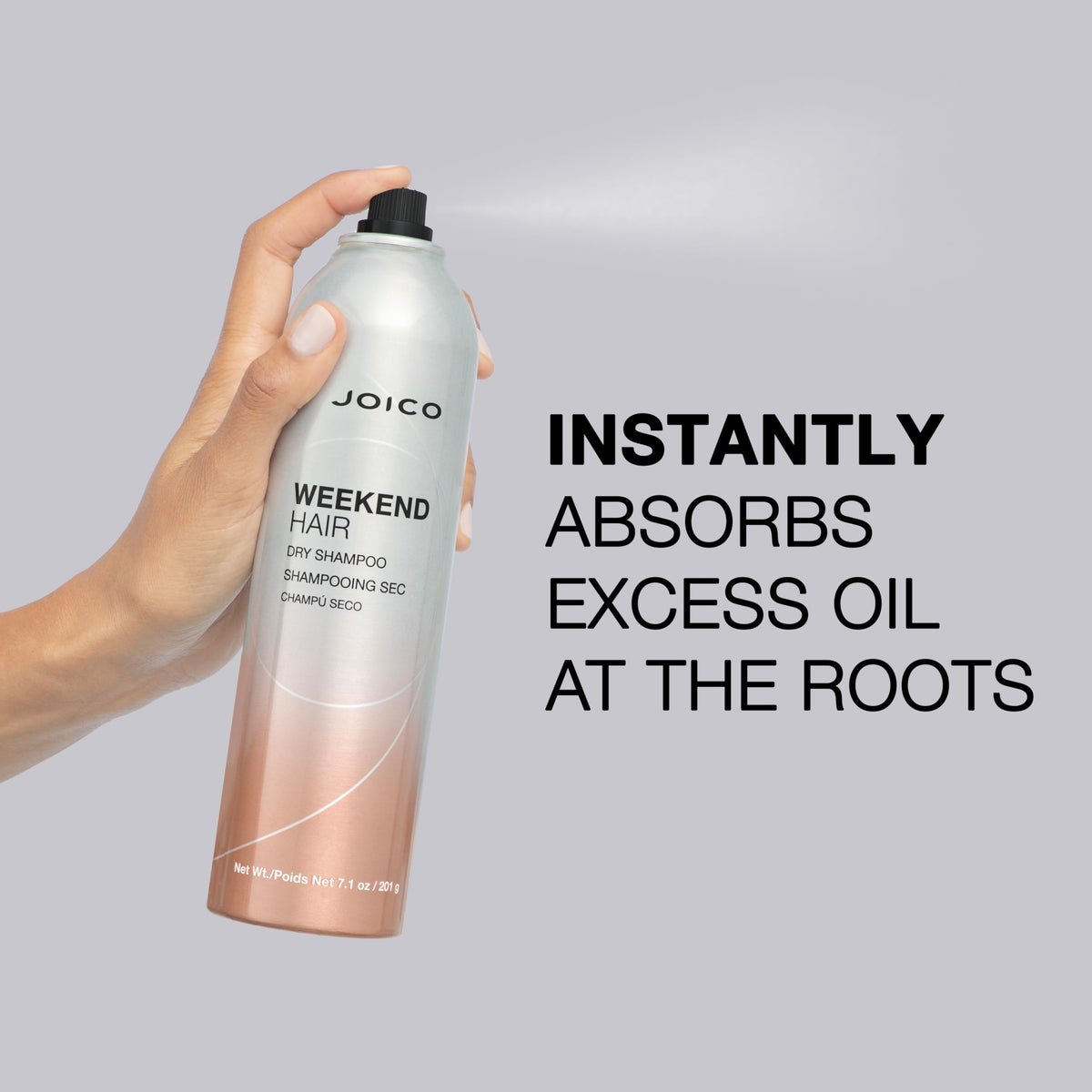Joico bottle next to hand to show 7.1 oz scale and portability