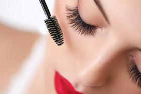 JOLIE navy mascara on model applying lashes demonstrating soft natural enhancement