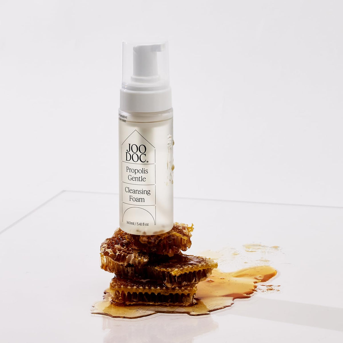 JOODOC bottle held in hand for size and scale to show the 160ml travel-friendly volume