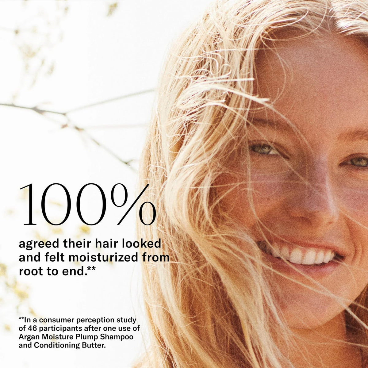 Josie Maran product in hand applying lather to hair for visible foaming action