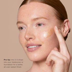 Jouer dropper releasing serum to show lightweight texture and buildable glow